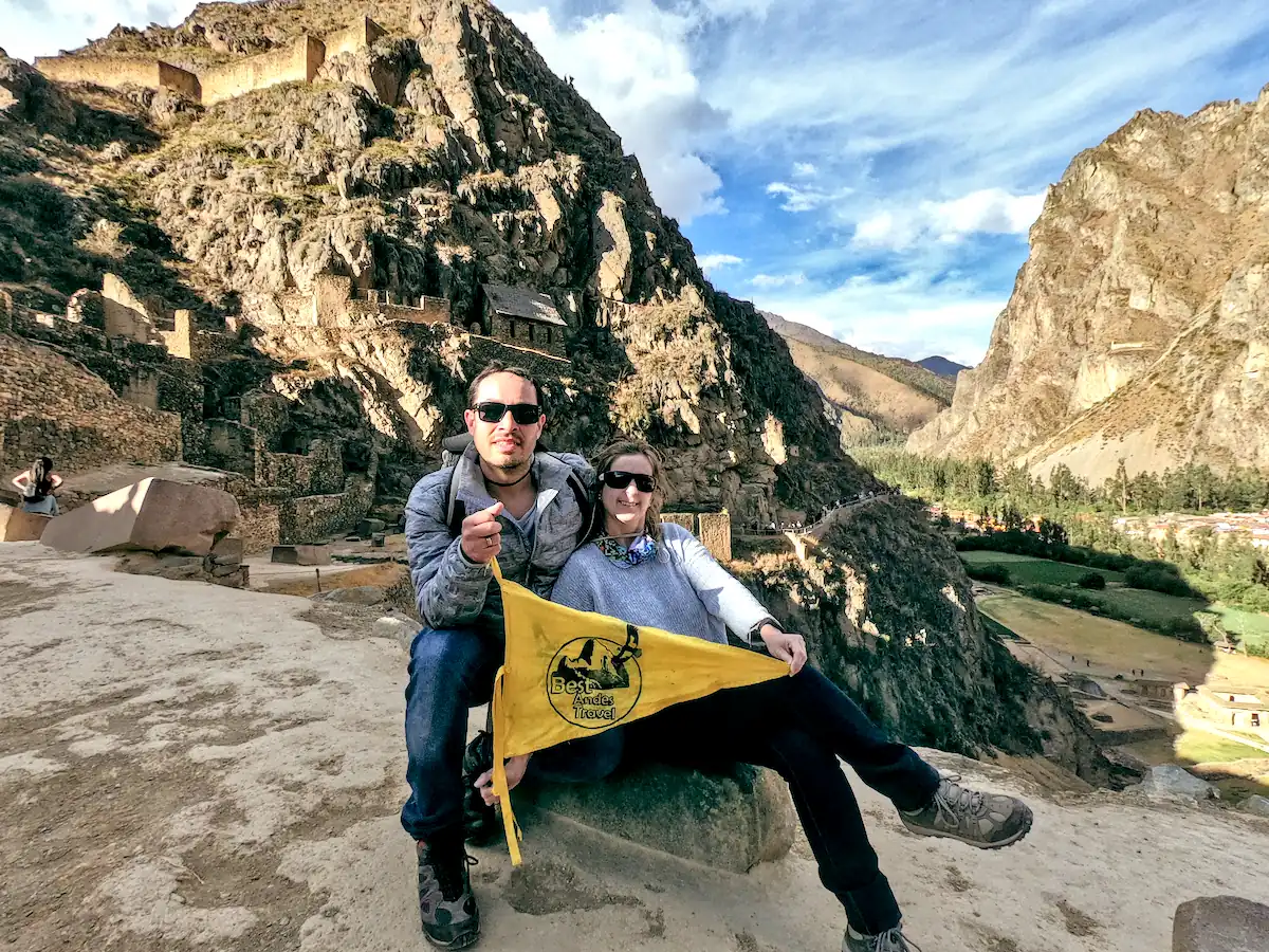 Couple Posing With A Best Andes Travel Banner At Ollantaytambo Ruins