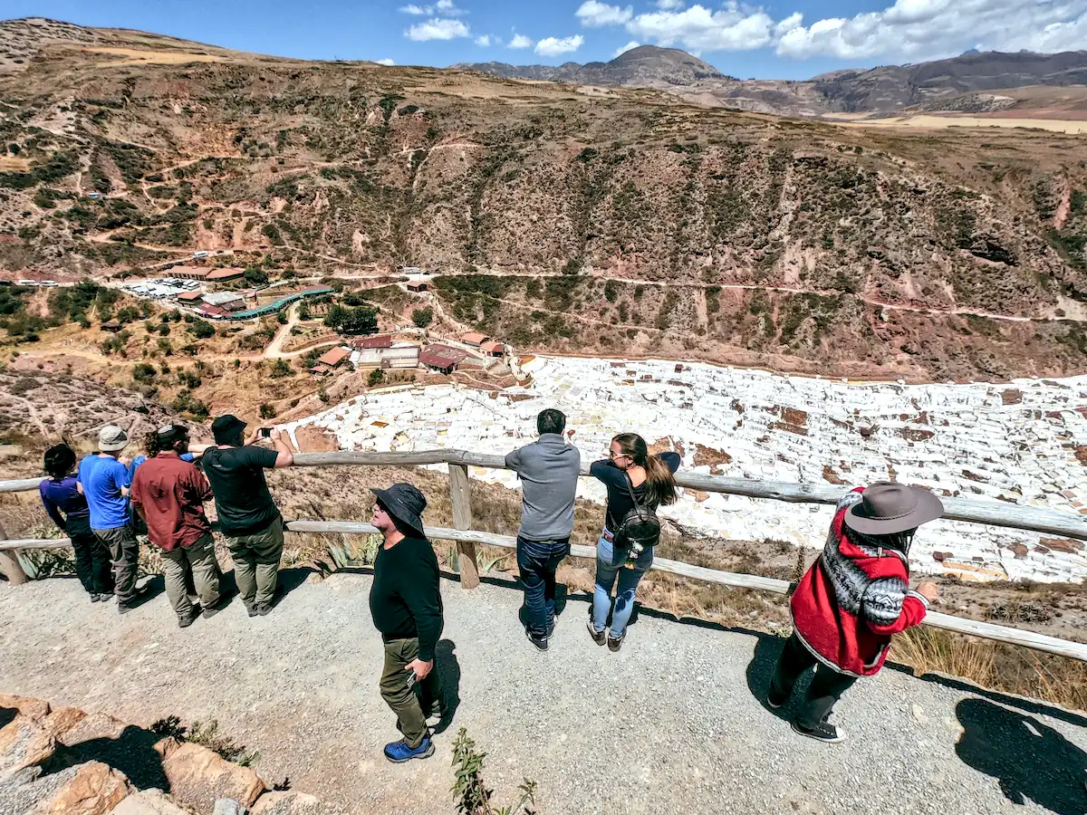 Tourists Overlooking The Expansive Maras Salt Ponds And Terraces
